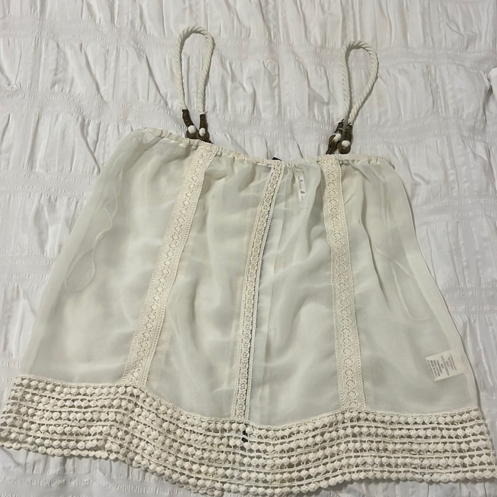 Women’s ivory top with twist rope strap